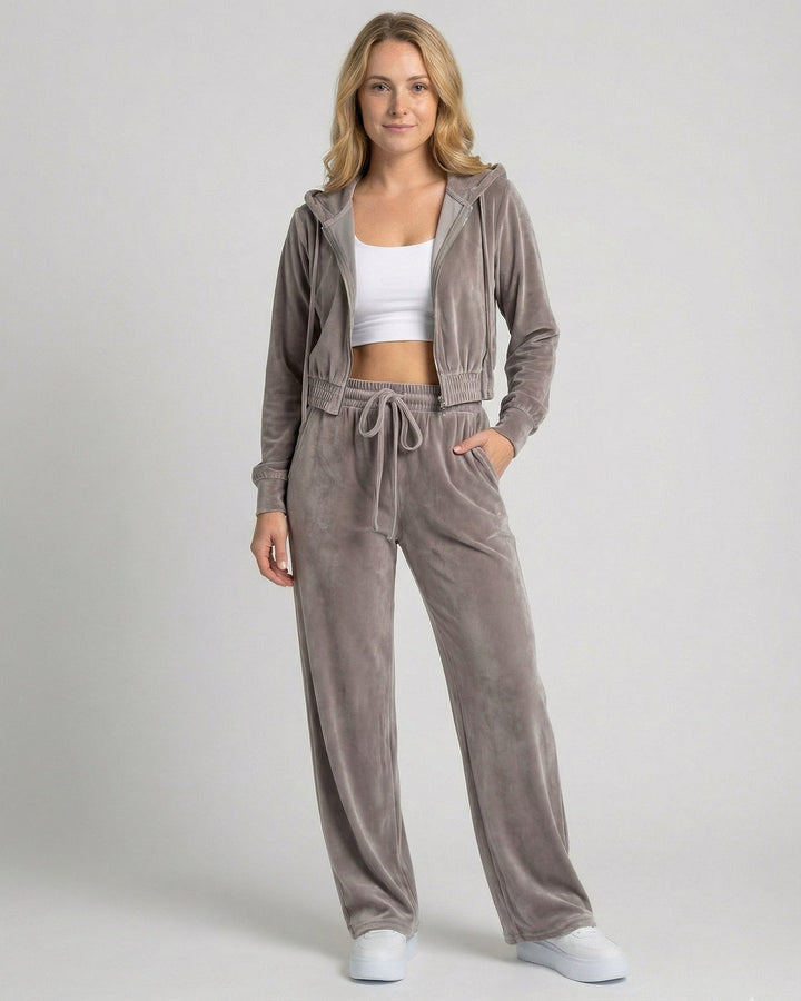 Grey velour tracksuit with cropped zip-up hoodie worn over a white crop top, front view