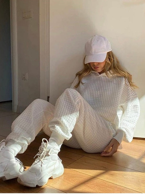 White waffle tracksuit with hoodie and joggers, sitting on the floor