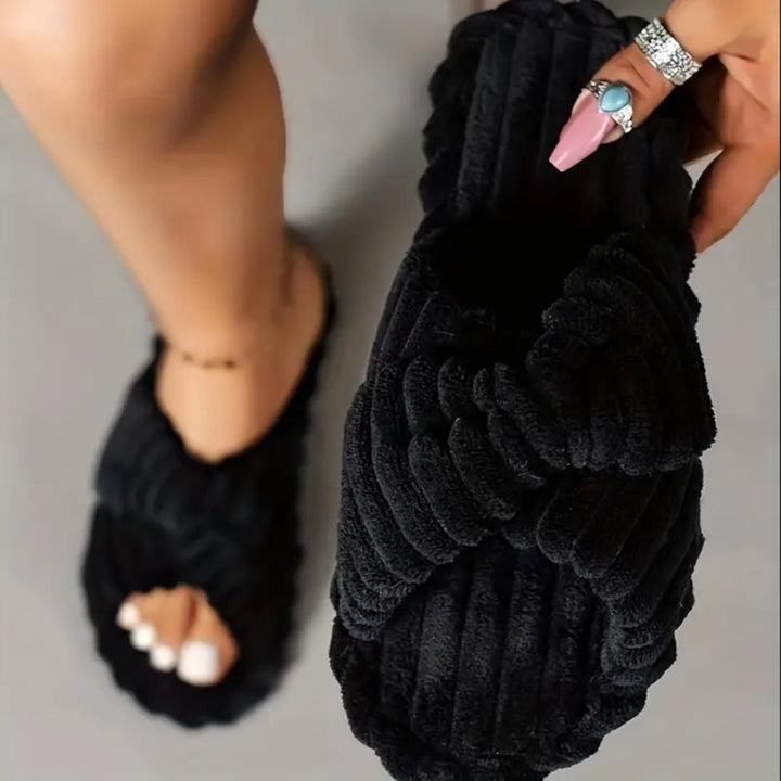 Black open-toe slippers with a crossover ribbed plush upper