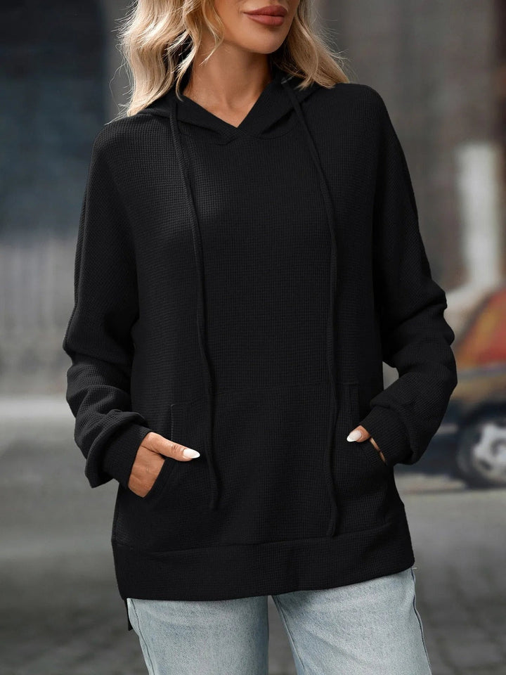 Woman wearing a black waffle hoodie with light jeans | Grace Aura