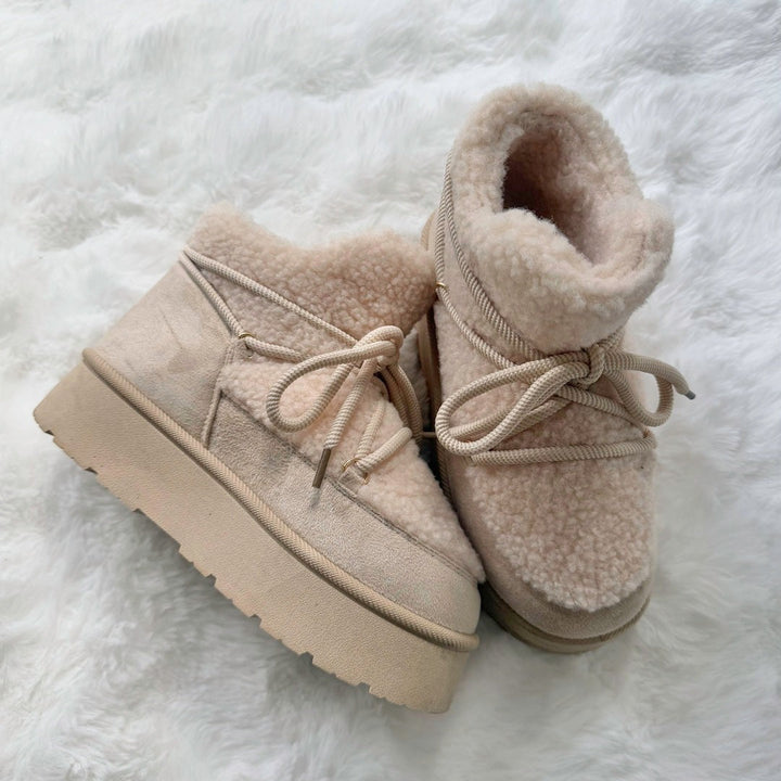 Pair of beige teddy platform ankle boots
