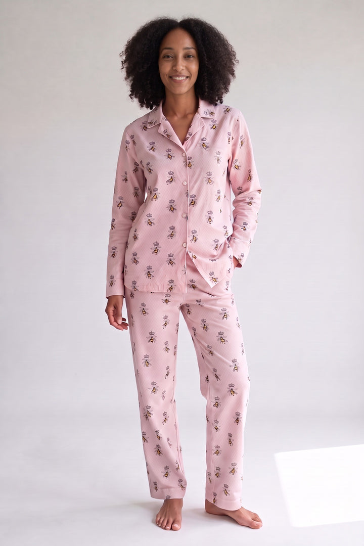 Pink flannel pyjamas with a crowned bee print, worn, front view