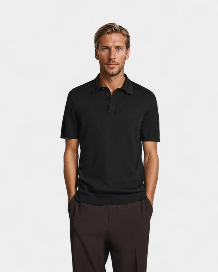 Man wearing black knitted polo shirt with brown trousers, standing pose | Grace Aura
