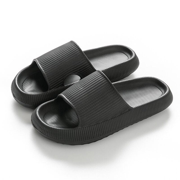 Black rubber cushioned slide sandals with ribbed texture, shown as a pair | Grace Aura