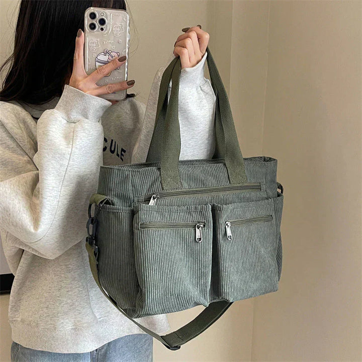 Woman holding sage green corduroy multi-pocket shoulder bag, mirror selfie | Grace Aura