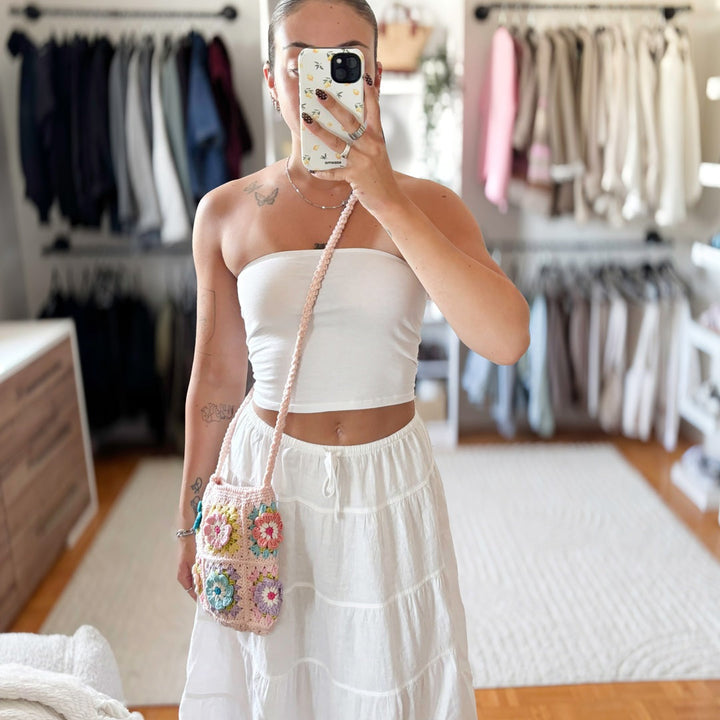 Woman wearing white crop top and skirt with crochet crossbody bag | Grace Aura