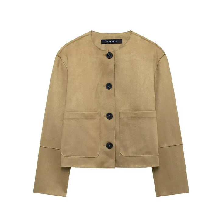Beige collarless jacket with dark buttons and patch pockets, flat lay | Grace Aura
