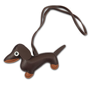 Brown leather dachshund-shaped bag charm with strap, shown flat, tan accents | Grace Aura