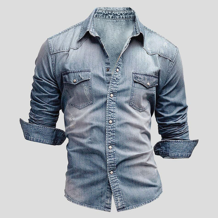 Faded blue denim button-up shirt with chest pockets, worn by model | Grace Aura