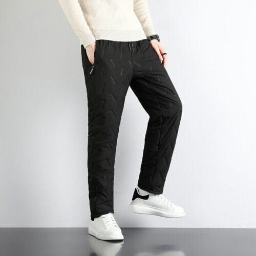 Black quilted drawstring pants worn by man with white sneakers | Grace Aura