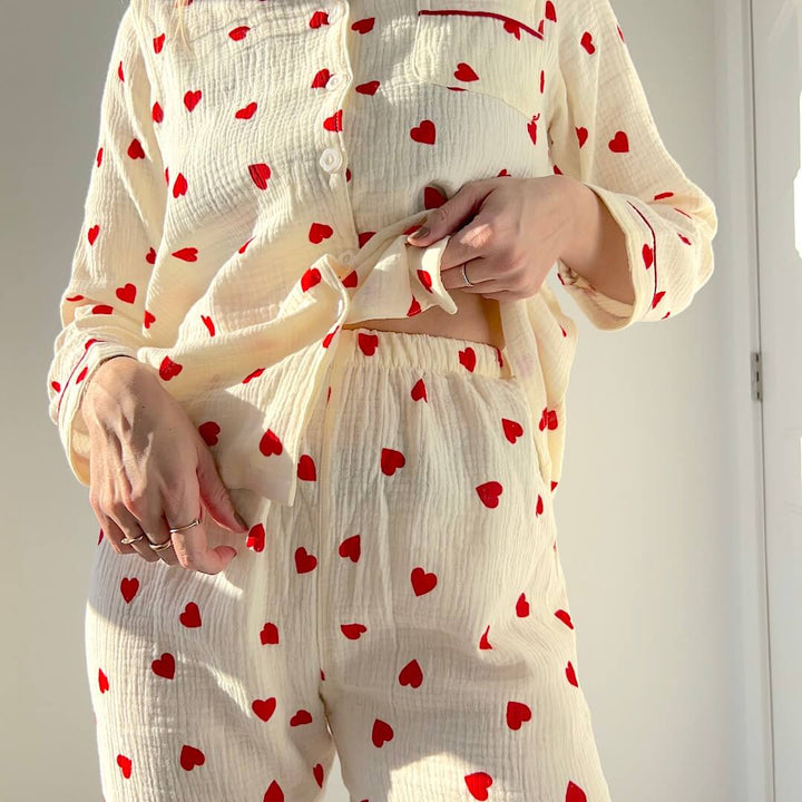 Woman wearing cream cotton pyjama set with red heart pattern | Grace Aura