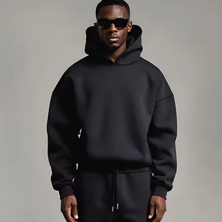 Man wearing black hoodie and matching jogger sweatpants, drawstring waist | Grace Aura