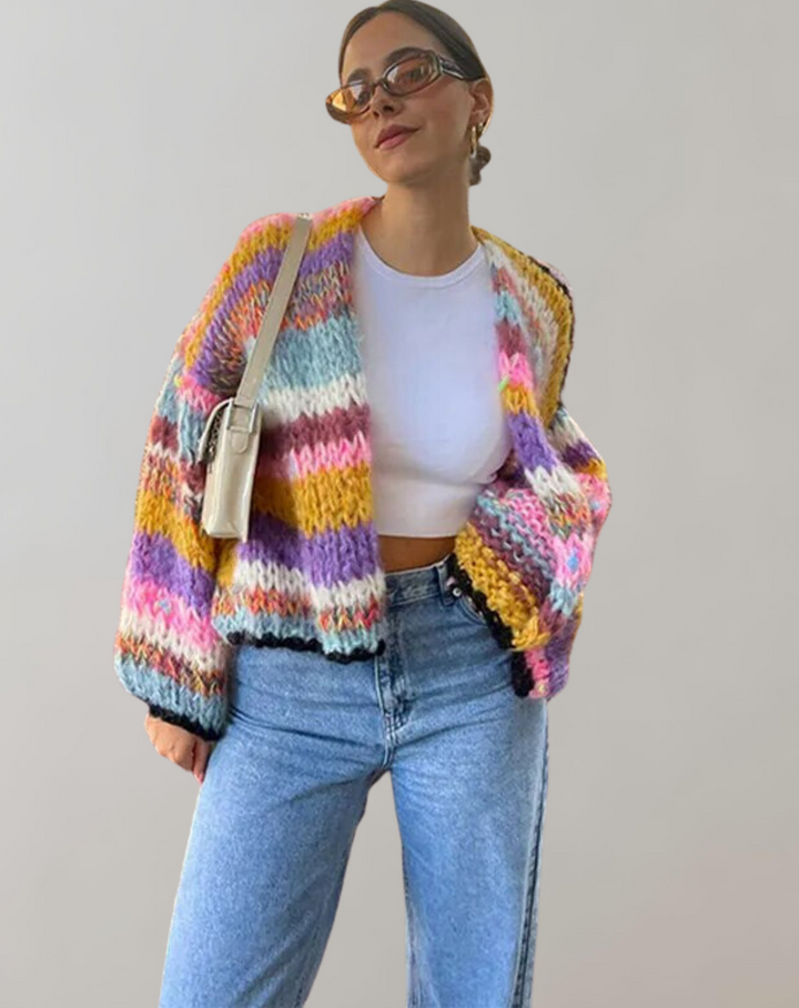 Woman wearing chunky multicolour striped knit cardigan with white top and jeans | Grace Aura