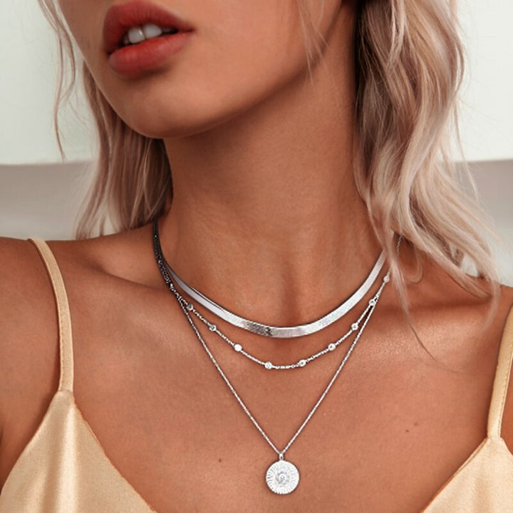 Silver layered necklace with flat chain and coin pendant worn by model | Grace Aura