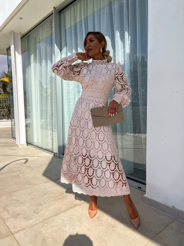 Woman wearing beige crochet lace long sleeve maxi dress with heels outdoors | Grace Aura