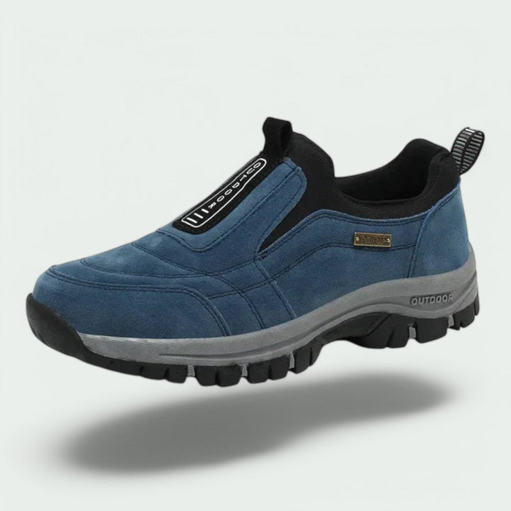 Blue suede slip-on hiking shoe with black rubber sole floating | Grace Aura