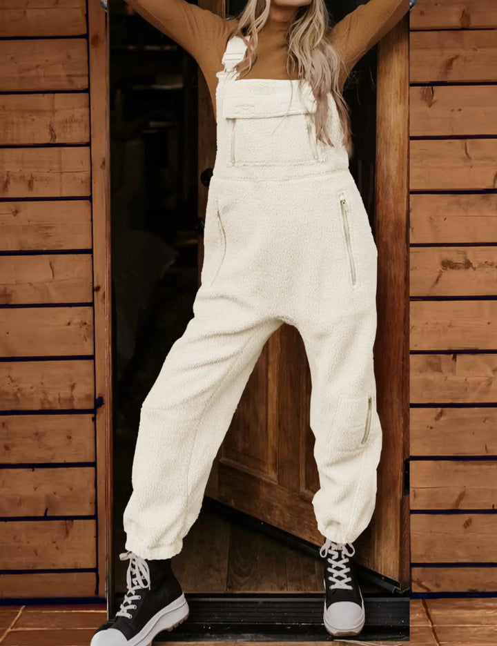 Cream fleece overalls worn by woman with black lace-up boots | Grace Aura