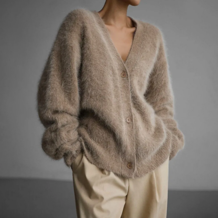 Woman wearing taupe fluffy oversized cardigan with button-up front, beige trousers | Grace Aura