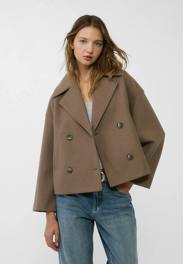 Woman wearing oversized taupe double-breasted short jacket with wide lapels | Grace Aura