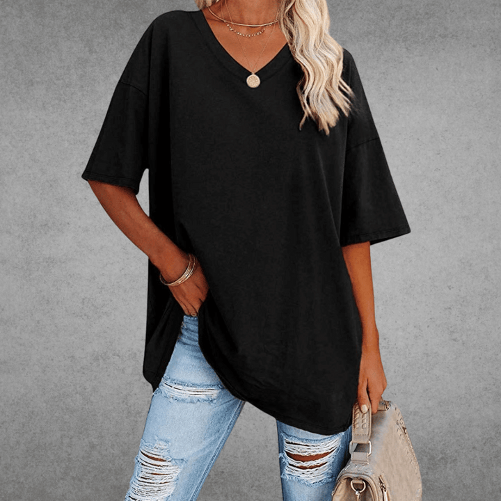 Black oversized V-neck T-shirt worn by woman with ripped jeans | Grace Aura