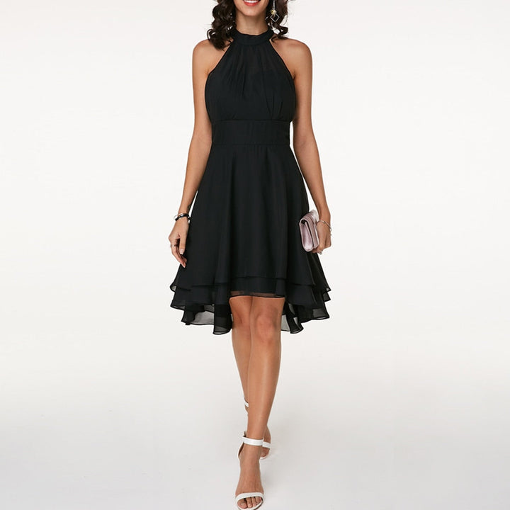 Black halterneck fit-and-flare cocktail dress with tiered hem, worn by model | Grace Aura