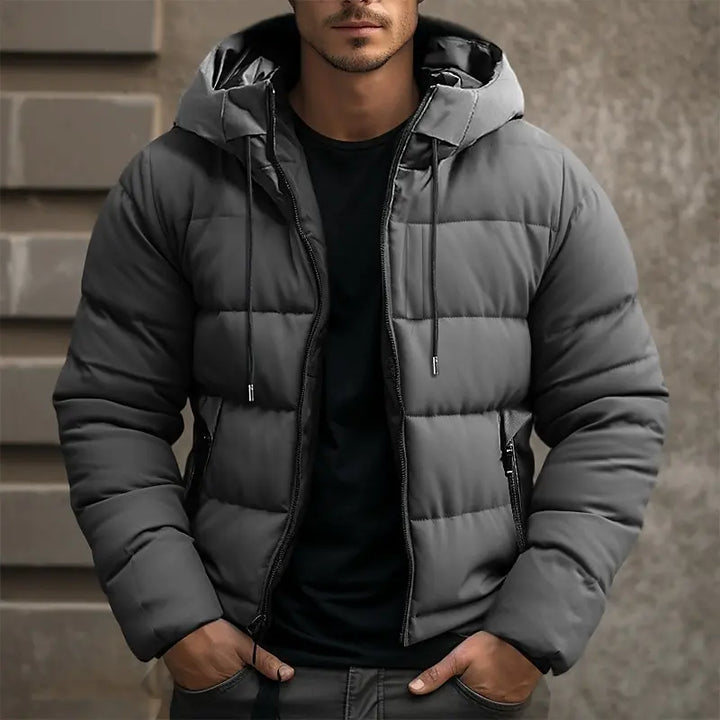 Gray hooded puffer jacket with zippered pockets worn by man | Grace Aura