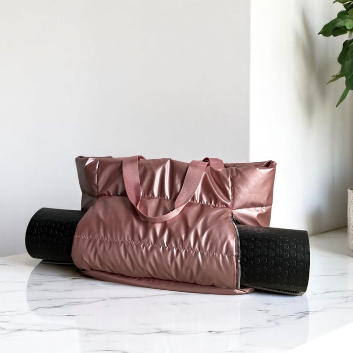 Mauve puffer tote bag with black rolled yoga mat, flat surface | Grace Aura