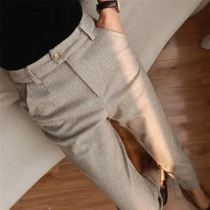 Beige tweed high-waisted trousers with button detail, worn by seated person | Grace Aura