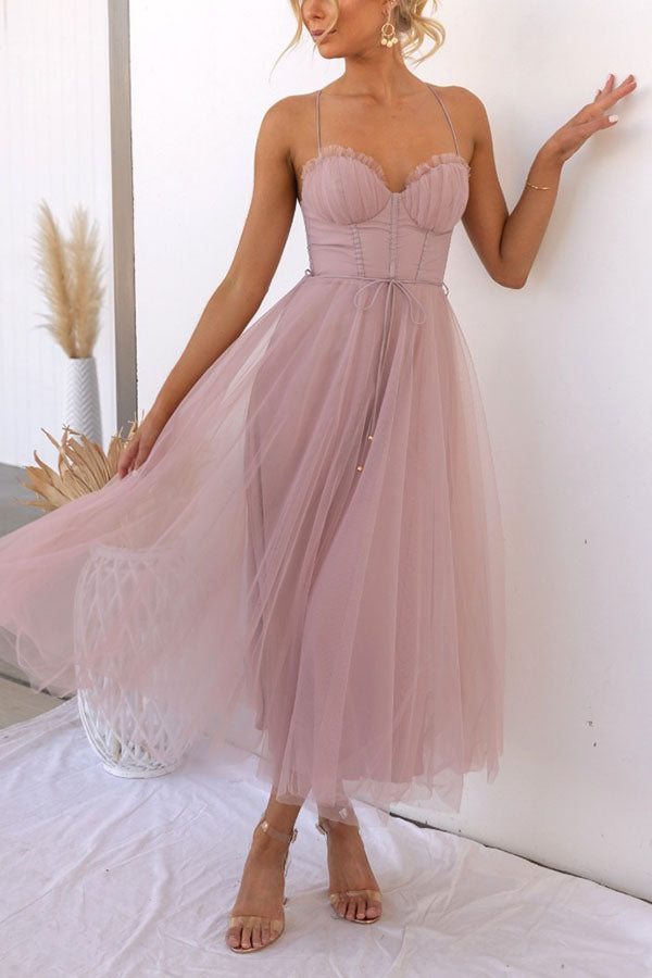 Blush pink tulle midi corset dress worn by woman, sweetheart neckline | Grace Aura