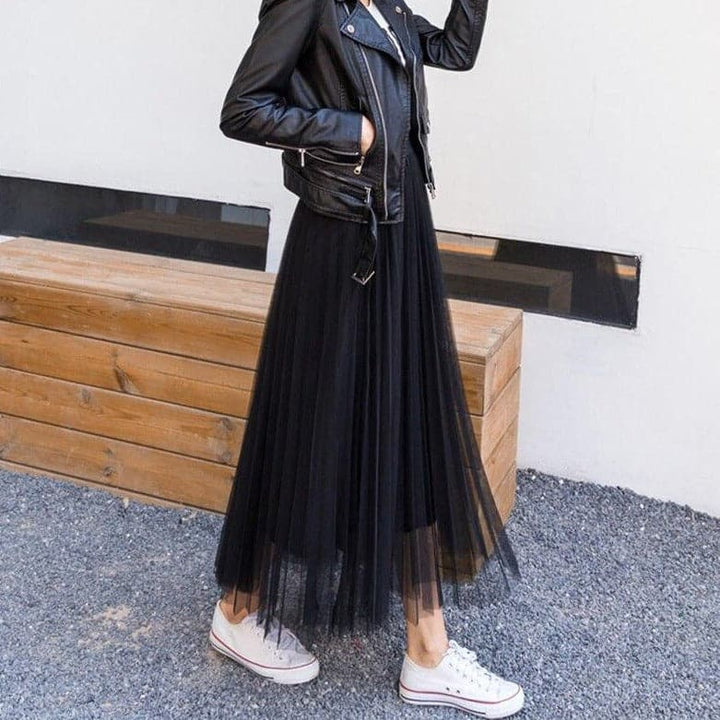 Black tulle maxi skirt worn with leather jacket and white sneakers | Grace Aura