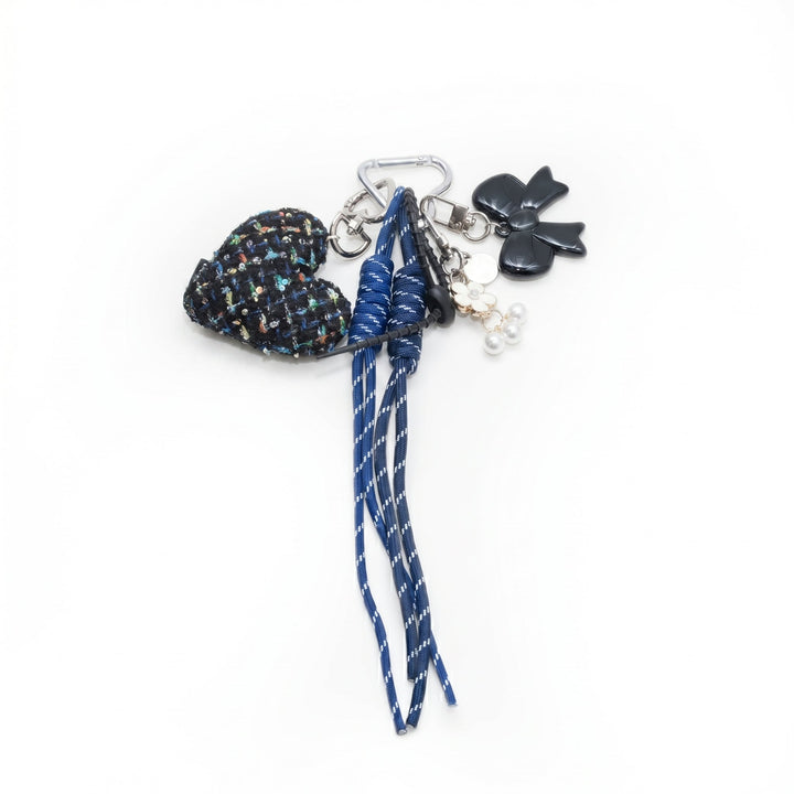 Tweed heart bag charm with blue cords and black flower charm, flat lay | Grace Aura