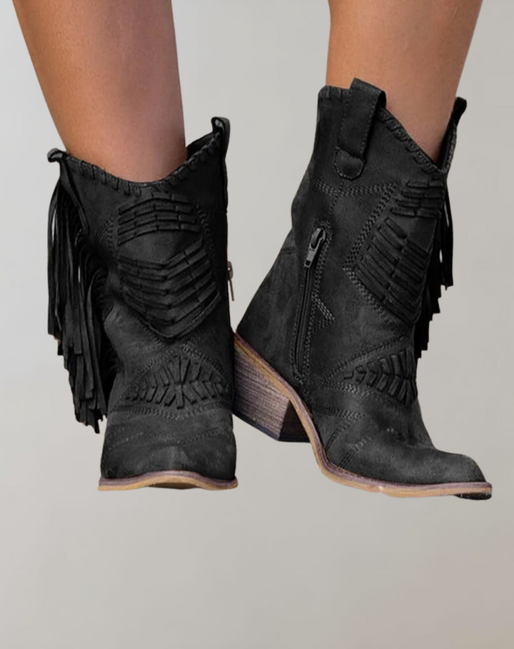 Black fringed ankle boots with woven stitch pattern, worn on feet | Grace Aura