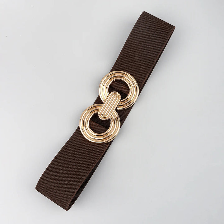 Brown elastic stretch belt with gold double-ring interlocking buckle, laid flat | Grace Aura