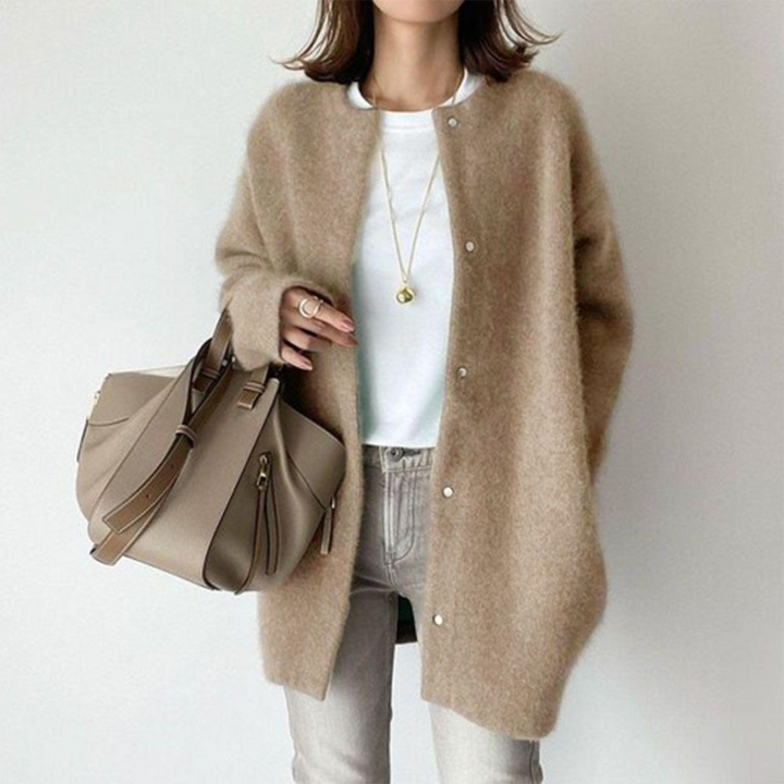 Beige oversized knitted button-up cardigan worn by woman with tote bag | Grace Aura