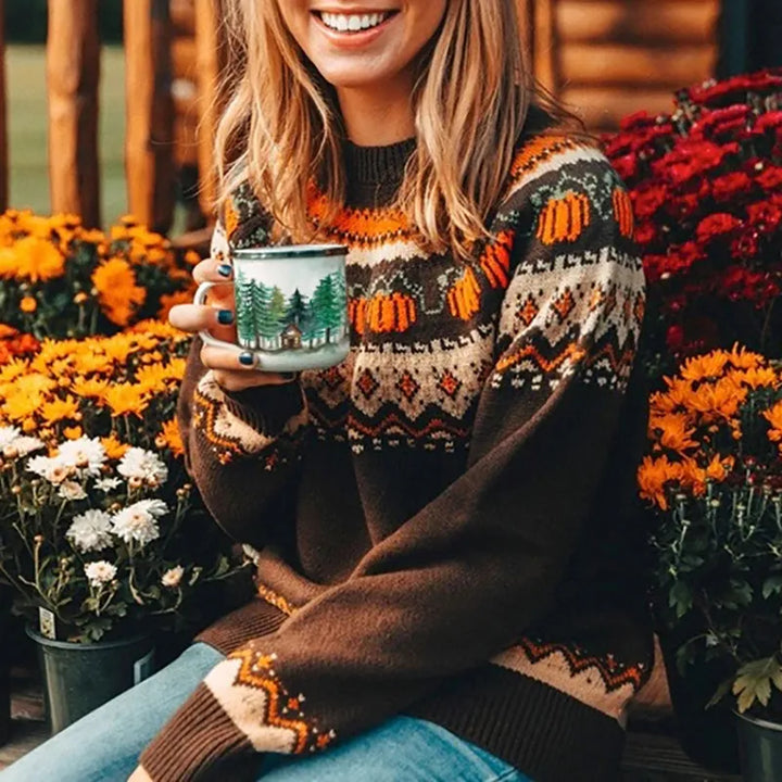 Woman wearing brown knitted jumper with pumpkin and pine tree pattern | Grace Aura