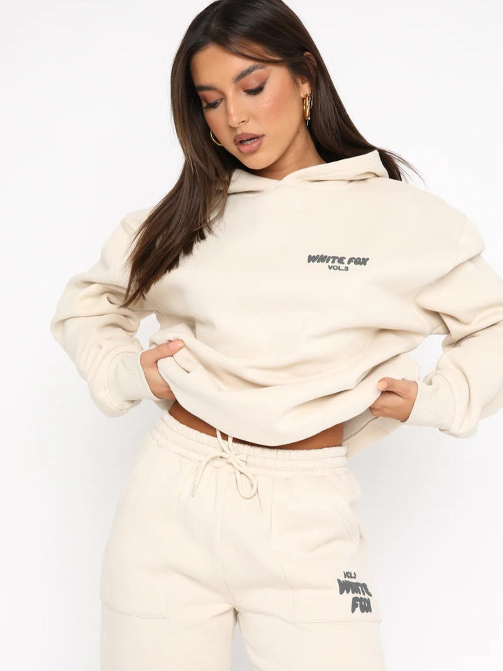 Woman wearing beige cropped hoodie and matching drawstring sweatpants jogger set | Grace Aura