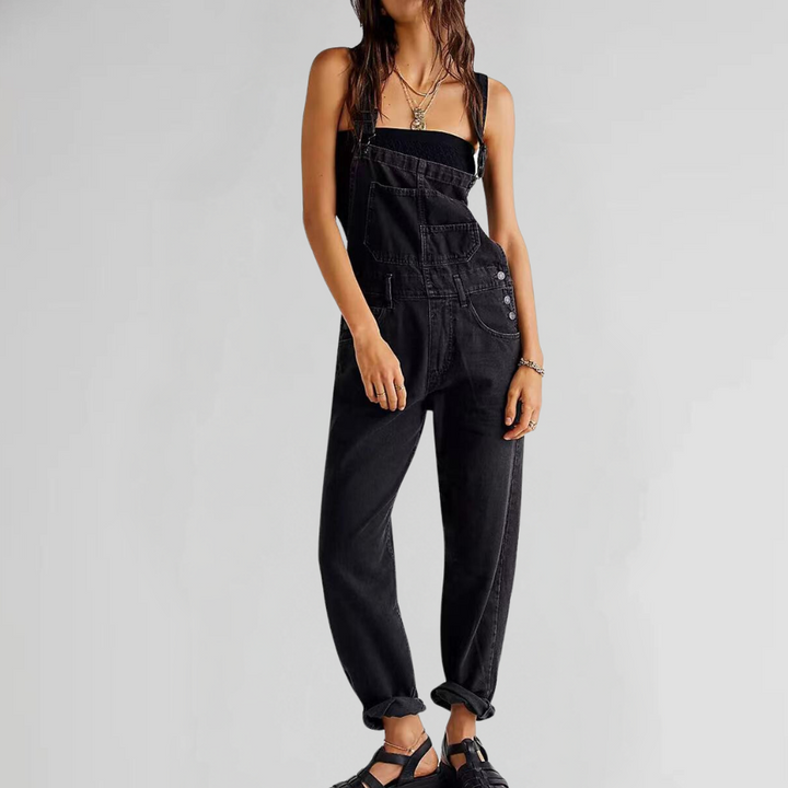 Black denim overalls worn by woman, layered over black top, cuffed hems | Grace Aura