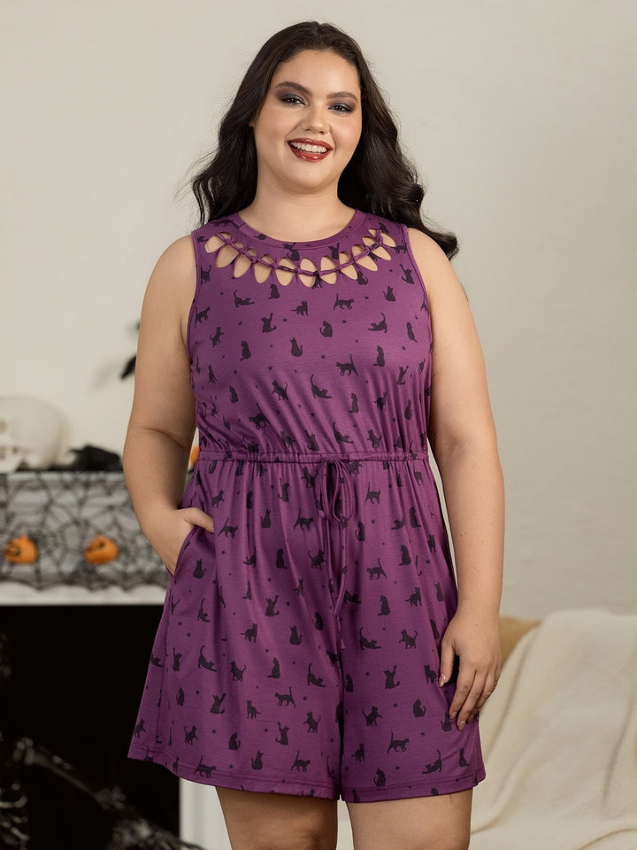 Woman in the plum cat print playsuit at home with Halloween decorations