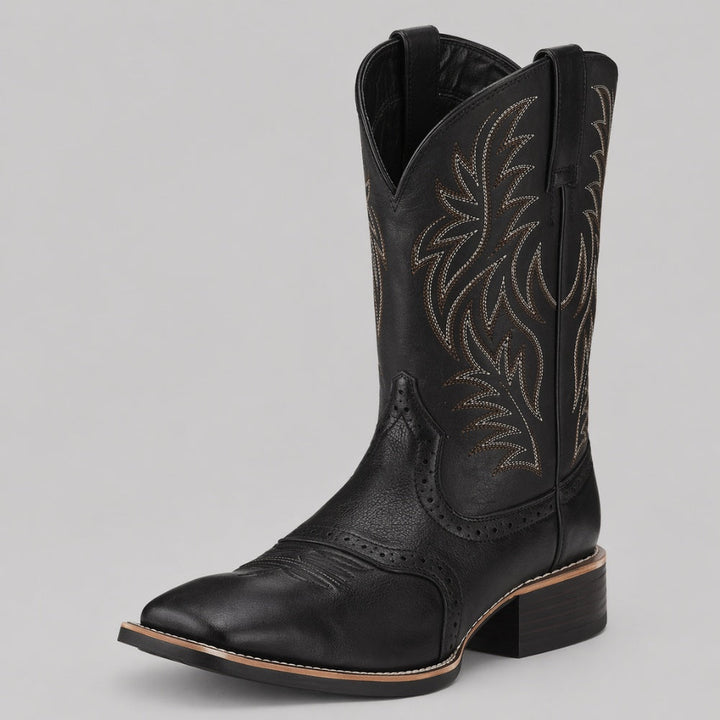 Black cowboy boot with contrast stitching, pointed toe, shown standalone | Grace Aura