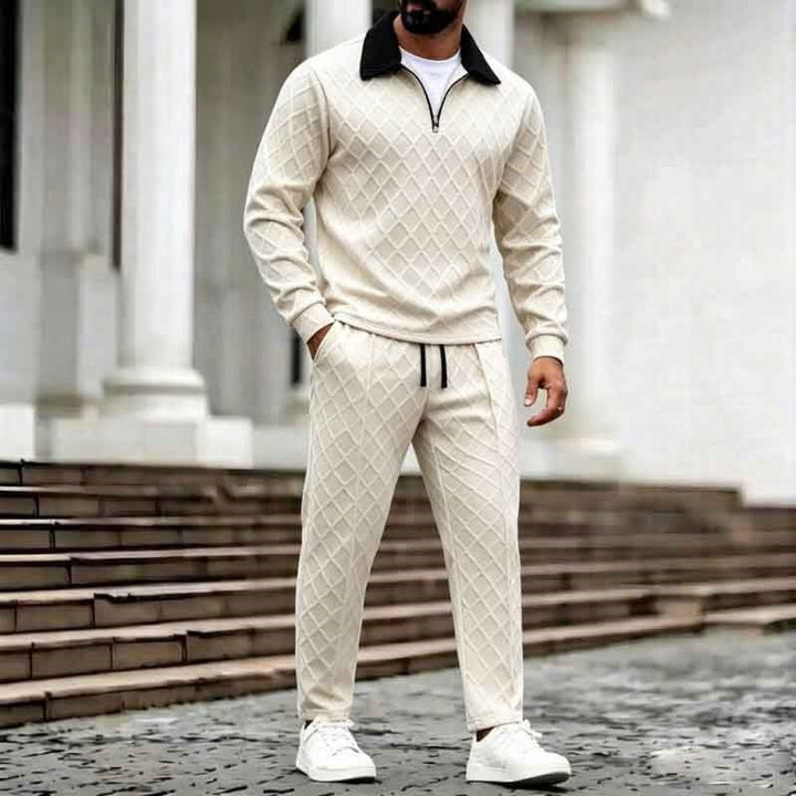 Man wearing cream diamond-textured half zip sweater and matching pants outdoors | Grace Aura