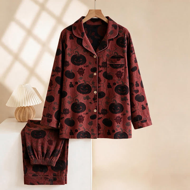 Red and black pajama set with pumpkin print, hanging on hanger | Grace Aura