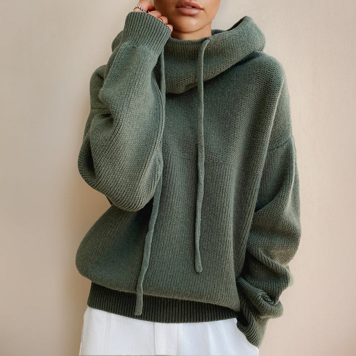 Sage green funnel neck hoodie worn by woman, oversized fit, drawstring detail | Grace Aura