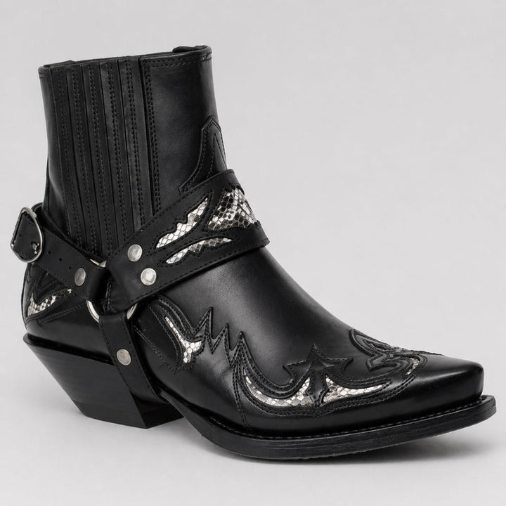 Black ankle cowboy boot with silver snake-print harness strap detail | Grace Aura