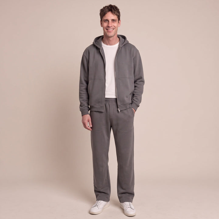Man wearing dark grey zip hoodie and matching jogger sweatpants outfit | Grace Aura