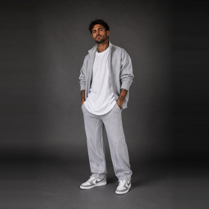 Man wearing light grey zip jacket with matching joggers and white t-shirt | Grace Aura