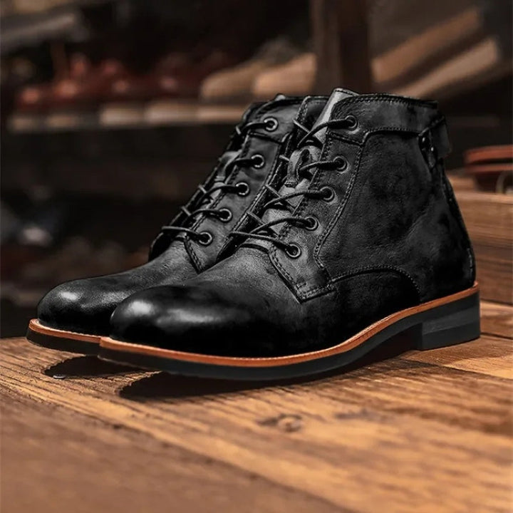Black lace-up ankle boots with stacked heel, shown on wooden surface | Grace Aura