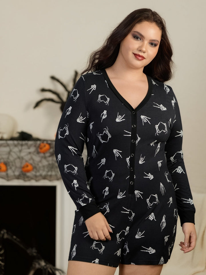 Woman in the black skeleton hands playsuit at home with Halloween decorations