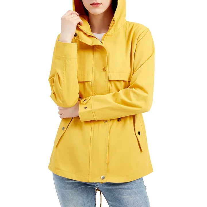 Woman in a yellow hooded rain jacket with the hood up