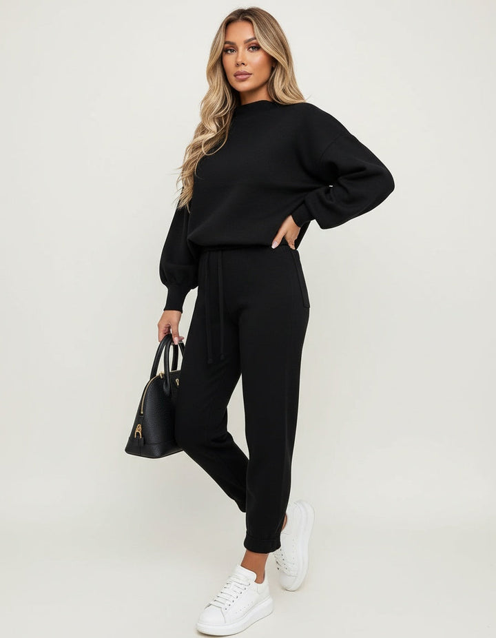 Knitted lounge set with jumper and joggers in black, worn, front view