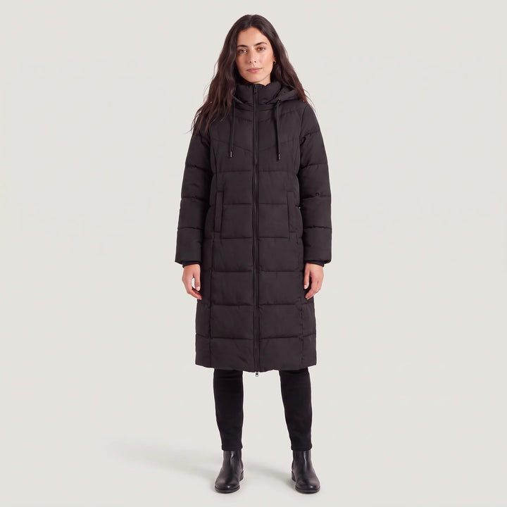 Woman in a long black puffer coat with hood